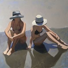 two women sitting on the beach wearing hats