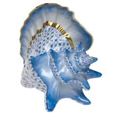 a blue and white sea shell with gold accents