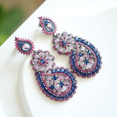 keywords: Jhumka Kundan earrings/statement dangles/wedding jewelry/cultural accessory/anniversary Indian multi-stone handmade/aesthetic Christmas There is another pink-blue color, kindly check the link below  https://www.etsy.com/listing/1779611224/jhumka-kundan-earringsstatement?click_key=ccbc588d6416b13c0f2c3904fb7fbe75a19fe507%3A1779611224&click_sum=074f901b&ref=shop_home_active_54&pro=1&frs=1 👄Item details:  Originally designed by me and crafted in our Denver, Colorado studio, our family business thrives with the invaluable contributions of my brother and cousin, who play key roles in creating our items and maintaining our Etsy shop. Specifications: *Length:50mm *Width: 30mm *Materials: Stainless steel, vibrant quartz stones, handmade settings, featuring original vintage Kundan Jhumka Handmade Blue Danglers For Wedding, Purple Jeweled Earrings As Gift, Purple Jeweled Earrings For Gift, Bohemian Purple Earrings For Wedding, Traditional Purple Drop Earrings, Traditional Purple Teardrop Jewelry, Purple Jeweled Drop Earrings, Handmade Blue Elegant Danglers, Blue Elegant Handmade Danglers