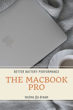 the macbook pro is sitting on top of a blanket next to a cup of coffee