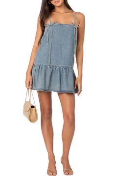 Traditionally rugged denim gets a date-ready makeover in this all-cotton shift dress made even sweeter with dainty bow straps and a ruffled hem. Slips on over head Square neck Adjustable tie straps 100% cotton Machine wash, line dry Imported Summer Denim Blue Mini Dress With Frayed Hem, Denim Blue Mini Dress With Frayed Hem For Summer, Summer Denim Mini Dress With Frayed Hem, Denim Mini Dress With Frayed Hem For Summer, Denim Blue Mini Dress With Frayed Hem For Spring, Medium Wash Denim Mini Dress With Frayed Hem, Medium Wash Denim Dress With Ruffles, Spring Denim Dress With Frayed Hem In Medium Wash, Spring Denim Blue Dress With Ruffle Hem