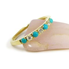 This Turquoise and diamond ring is a beautiful way to say “I love you.” Handmade from 14 karats yellow gold, this stacking ring features seven rounded gemstones alternating between 0.1-carat diamonds and bright blue turquoise. The 2 mm gemstones are almost flush with the 2.4 mm-wide band, creating a stunning pave effect. This beautiful accessory is available in any standard ring size. #jonjonjewel #BohoRing #TurquoiseRing #RingforWomen #TurquoiseJewelry #TurquoiseDiamondRing Gold Turquoise Stackable Ring, Turwuoise Wedding Ring Stacker, Wedding Ring Turquoise, Gold Multi-stone Turquoise Ring For Wedding, Gold Turquoise Ring For Wedding, Fine Jewelry, Luxury Multi-stone Gold Turquoise Ring, Turquoise Diamond Ring, Turquoise And Diamond Ring, Etsy Engagement Rings Unique