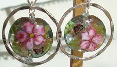 "This is a set of earrings I designed using lampwork focal (handmade artisan glass) from Joyce, 3mm light aquamarine bi-cone swarovski crystals, hammered sterling hoops, and all sterling findings. This lampwork has a beautiful pink flowers upon its surface with tiny little butterflies fluttering around a sparkling green/blue core. The camera just can't capture the wonderful colors and sparkles that are in this gorgeous piece of artwork.. These sterling hoop earrings measure 1 1/8\" around on the Decoupage Jewelry, Decoupage Jewelry Box, Blue Core, Pink Passion, Beautiful Pink Flowers, Crystal Hoop Earrings, Earrings Pink, Silver Crystal, Jewelry Earrings Hoops