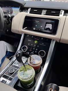 the interior of a car with two drinks in each cup and an automatic drink dispenser