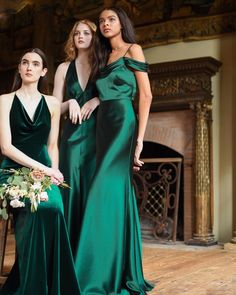 two women in green dresses standing next to each other