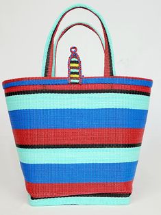 Material: Recycled plastic. Color: Red, blue, sky blue, black. Size: Height 12" Width 14" Use: Grocery, beach, pool... Property: Waterproof, easy to clean. Origin: West Africa. Handwoven bags made from recycled plastics. This bag is waterproof and very easy to clean. This material is very strong and can hold heavy contain.