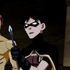 batman and robin wayne standing next to each other in front of a dark room with lights on