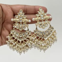 Bollywood Kundan Earrings/Indian Earrings/pearl Earring/Pakistani Earrings/Statement Earrings/Long chandelier/bridal earring/Indian wedding Style 1 Height = 90 mm || Width = 65 mm Style 2 Height = 85 mm || Width = 55 mm Bollywood Look Indo Western Earring Handmade Design Arrives in a gift box Color, shades, texture displayed may slightly vary from the actual product due to digital image limitations. We request you to consider these minor variations. Please expect the possibility of some slight imperfections when buying handmade jewelry. If you have any questions, please contact us. Luxury Kundan Bollywood Chandelier Earrings, Luxury Kundan Chandelier Earrings For Diwali, Bollywood Pearl Drop Chandelier Earrings For Receptions, Bollywood Style Pearl Drop Chandelier Earrings For Reception, Traditional Pearl Bridal Drop Earrings, Traditional Pearl Drop Bridal Earrings, Wedding Chandbali Pearl Earrings, Kundan Chandelier Earrings With Pearl Drop For Wedding, White Kundan Chandelier Earrings For Wedding