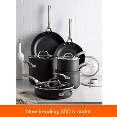 pots and pans on a counter with the words now trending $ 50 & under