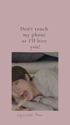 a woman laying in bed with the caption don't touch my phone or i'll bite you