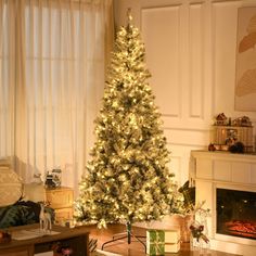 a living room with a lit christmas tree in the corner and presents on the floor