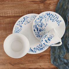 blue and white porcelain dishes on a wooden table