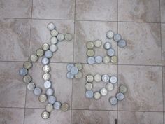 some cans are laying on the floor and one is empty with coins scattered around it