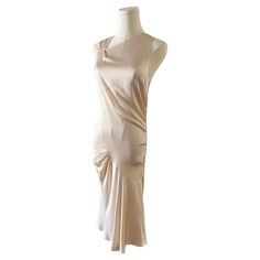 This hammered silk dress by John Galliano for Christian Dior in a light ivory/blush is just waiting for a bridal shower, rehearsal dinner, courthouse wedding, or any garden party. With signature Dior buttons down the side, gathered pleats, and bias draping, this timeless dress is a classic. The dress will accommodate a range of sizes and shapes because of the fabric's give. French size 38, US 6 Bias Draping, French Wedding Dress, 20th Century Fashion, Timeless Dress, Light Ivory, Courthouse Wedding, Tweed Dress, Mini Velvet Dress, John Galliano