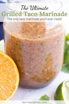 the ultimate grilled taco marinade in a mason jar with an orange slice next to it