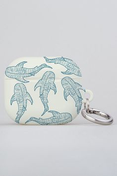 a white case with blue dolphins on it and a key chain hanging from the front