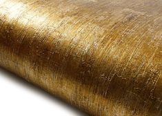 a close up view of a gold wallpaper with metallic foiling on it's surface