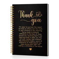 a black notebook with gold lettering that says thank you