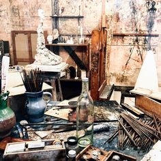 an old room filled with lots of clutter and bottles on top of a table