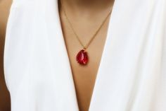 "A vivid Ruby pendant necklace handcrafted to be a perfect addition to your jewelry collection. A lovely necklace that frames a pear-cut Ruby gemstone in prongs. A lustrous addition to assembling your style statement or a luxurious gift for her special day. ♥ Gemstone Type - Ruby (Lab Created) ♥ Gemstone Size - 16x20mm ♥ Gemstone Cut - Pear - More options available in the drop down menu ♥ Metal Type (Main Photo) - 14k Gold Filled - More options available in the drop down menu ♥ Length (Model Pho Fine Jewelry Ruby Teardrop Necklace, Teardrop Ruby Necklace In Yellow Gold, Fine Jewelry Ruby Teardrop Pendant Necklace, Formal Pear-shaped Ruby Necklace, Pear-shaped Ruby Gemstone Necklace, Ruby Necklace Pendant, Large Pendant Necklace, Peridot Necklace, Ruby Pendant