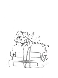 a rose sitting on top of some books with a ribbon around it's neck