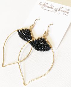 "Organic flowing lotus shape hoop and faceted black spinel rondelle beads. These elegant hoop are super light and comfortable to wear. Lotus hoop were hand forged and textured for extra shine using gold filled wire. Handmade gold filled french ear wires. Lotus hoop are about 1.5 x 2 inches in size. This rich and regal gemstone ranges in color from pale pink to deepest black. In fact, the spinel is known as the \"great imposter\" in the world of gemstones. Several of the \"rubies\" in the Queen o Black Small Hoop Jewelry For Parties, Black Faceted Bead Earrings For Gift, Black Faceted Beads Earrings For Gift, Elegant Hoop Earrings With Faceted Beads, Elegant Party Hoop Earrings With Faceted Beads, Small Hoop Jewelry With Faceted Beads For Gifts, Elegant Teardrop Black Bead Jewelry, Elegant Teardrop Black Beaded Jewelry, Party Hoop Jewelry With Faceted Beads