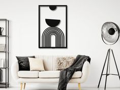 a living room with a white couch, black and white art work on the wall