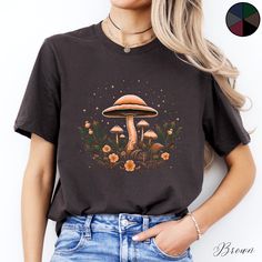 Celestial Mushroom and Flower Unisex Tee Shirt | Cottagecore Clothing | Botanical Boho Tshirt | Goblincore Aesthetic Clothes  ✔️ Soft, light and comfortable unisex short sleeve tee ✔️ 100% Airlume combed and ringspun cotton (fiber content may vary for different colours*) ✔️ Light fabric (4.2 oz/yd² (142 g/m ✔️ Retail fit 📏 Runs true to size ✔️ Dual side seams for structural support of the garment help hold its shape longer ✔️ Ribbed knit elastic collars to bolster shaping, twill taped shoulders Hippie Graphic Print T-shirt For Fall, Hippie Crew Neck T-shirt For Fall, Brown Bohemian Crew Neck T-shirt, Bohemian Brown Crew Neck T-shirt, Fall Mushroom Design Crew Neck T-shirt, Fall Crew Neck T-shirt With Mushroom Design, Black Graphic Tee With Mushroom Print, Fall Crew Neck T-shirt With Mushroom Print, Black Crew Neck T-shirt With Mushroom Print