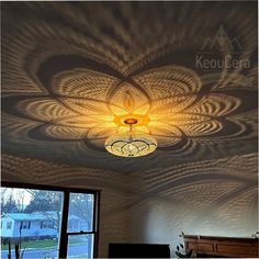 a room with a ceiling that has an intricate design on the ceiling and lights above it