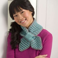 a woman wearing a knitted scarf and smiling