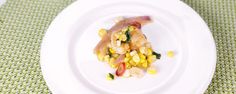 a white plate topped with food on top of a green tablecloth covered table cloth