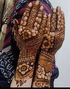 the hands are decorated with henna designs