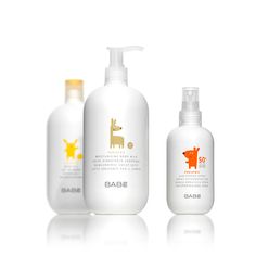 three bottles of baby lotion on a white background