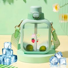 a green purse with fruit on it and ice cubes next to it in the foreground