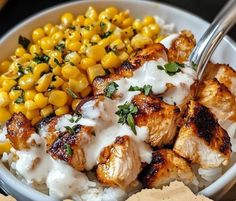 a white bowl filled with chicken, rice and corn