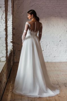 a woman in a wedding dress looking back