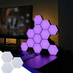 a computer desk with a purple hexagonal object on it