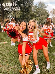 two cheerleaders posing for the camera with their pom poms