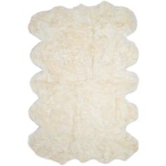 a white sheepskin rug on a white background