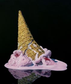 two scoops of ice cream are sitting on a plate with pink icing and raspberries