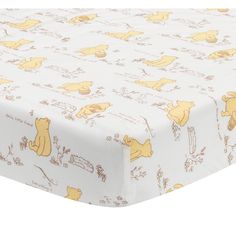 winnie the pooh crib sheet set with yellow and white print on it's bottom