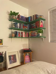 a bedroom with bookshelves and pictures on the wall