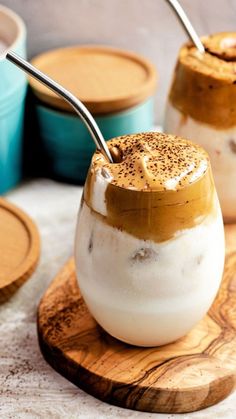 two desserts on wooden serving boards with spoons sticking out of them, sitting next to each other