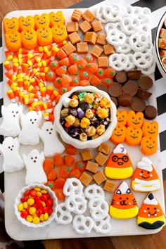 halloween treats are arranged on a platter with candy and candies in the shape of jack - o'- lanterns