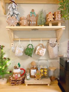 a shelf filled with christmas cookies and other holiday treats on top of a wooden table