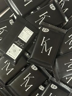 a pile of black and white monogrammed chocolate bars