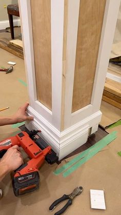 a man is working on an unfinished door