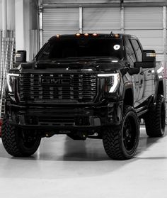 a large black truck parked in a garage