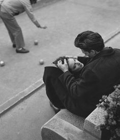 black and white photograph of a person sitting on a bench