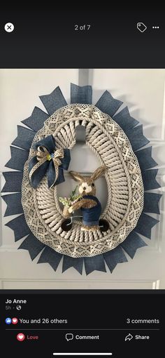 an image of a wreath made out of yarn and fabric with two rabbits on it